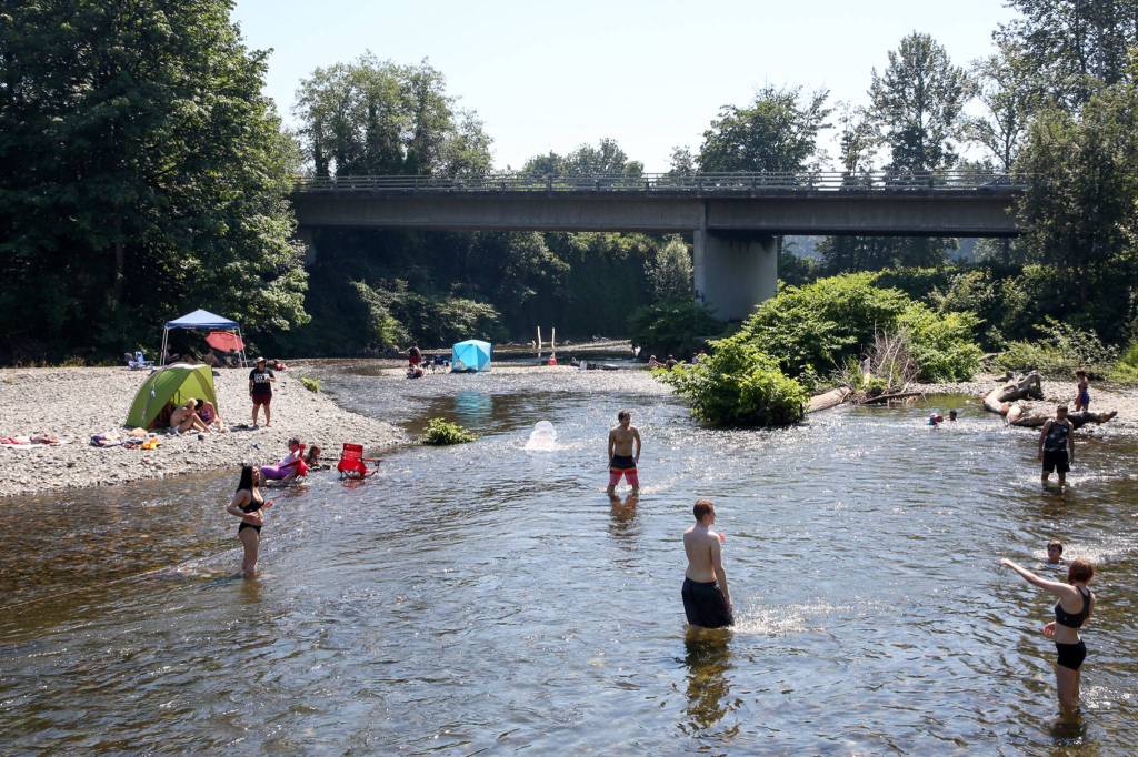 Cooling off in the Pilchuck River in Snohomish to get a break from record breaking heat Monday June 28th, 2021. (Kevin Clark / The Herald)