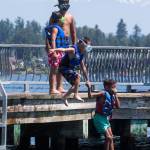 Kairee DeGrant, 7, leads Liam Dittrick, 4, into Lake Stevens at Davies Beach (formerly Willard Wyatt Park) on Tuesday. (Andy Bronson / The Herald)