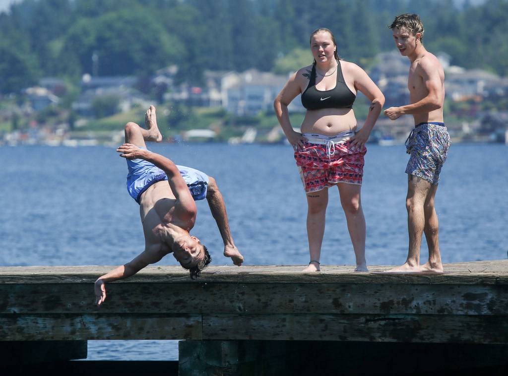 Andrian Enciso, 18, flips into Lake Stevens at Davies Beach (formerly Willard Wyatt Park) on Tuesday. (Andy Bronson / The Herald)