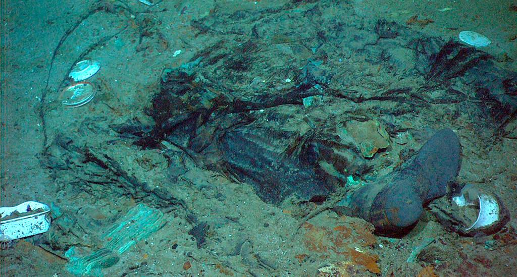 This 2004 photo shows the remains of a coat and boots in the mud on the sea bed near the Titanics stern. The 109-year-old wreck is being battered by deep-sea currents and metal-eating bacteria. (Institute for Exploration, Center for Archaeological Oceanography/University of Rhode Island/NOAA Office of Ocean Exploration)