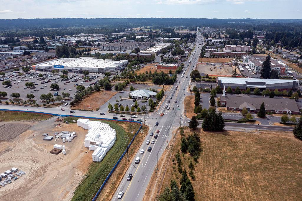 The growing business district along 172nd Street NE in Arlington, looking west toward I-5. At lower left is the construction site of the new Amazon fulfillment center. (Chuck Taylor / The Herald)