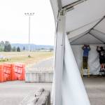 Jeff Irtter (left) and Tom Glasenapp dismantle a tent at the COVID vaccination station at the Evergreen State Fairgrounds in Monroe. (Kevin Clark / The Herald)