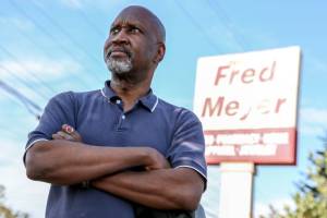 Wil Peterson is a cashier at Fred Meyer in Everett, but won't receive the temporary $4 per hour hazard pay increase that many grocery workers in unincorporated Snohomish County will receive.  (Kevin Clark / The Herald)