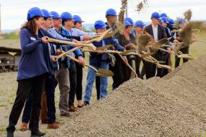 Community leaders and officials break ground at the Port of Everett's Norton Terminal at the former Kimberly-Clark mill site along the waterfront Thursday morning in Everett on July 15, 2021. (Kevin Clark / The Herald)