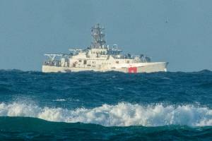 A U.S. Coast Guard cutter patrols the area of debris from a 737 cargo plane that crashed off Oahu, Friday, July 2, 2021, near Honolulu. The plane made an emergency landing in the Pacific Ocean off the coast of Hawaii early Friday and both people on board were rescued. The pilots of the Transair Flight 810 reported engine trouble and were attempting to return to Honolulu when they were forced to land the Boeing 737 in the water, the Federal Aviation Administration said in a statement. (Craig T. Kojima/Honolulu Star-Advertiser via AP)