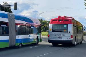 A Swift bus and an Everett Transit bus travel north on Rucker Avenue on Saturday in Everett. (Sue Misao / The Herald)