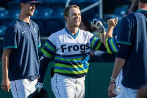 AquaSoxs Zach DeLoach is congratulated by his teammates after hitting a grand slam during the game against the Dust Devils on Sunday, May 16, 2021 in Everett, Wash.