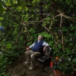 Bill Taylor sits in an area called Hobbit House in his garden Tuesday in Edmonds. The Taylors home is a stop on the Edmonds in Bloom garden tour to be held on July 18. (Andy Bronson / The Herald)
