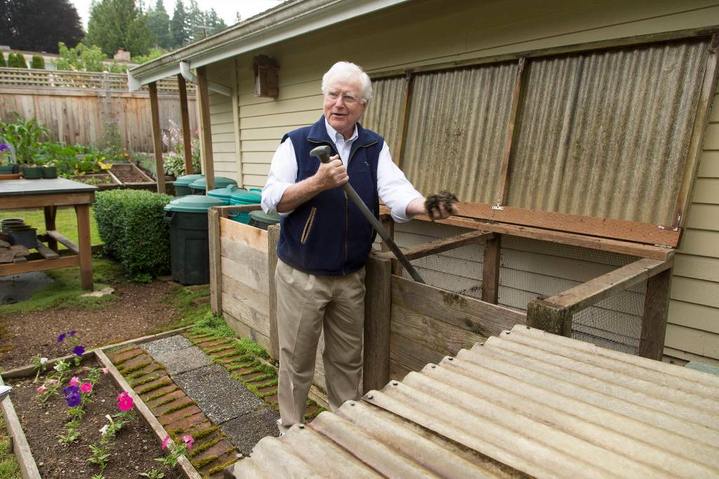 Bill Taylor home shows off his compost bins during a tour of his garden Tuesday in Edmonds. (Andy Bronson / The Herald)