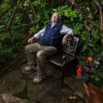 Bill Taylor sits in an area called "Hobbit House" in the southwest area of his garden on Tuesday, July 6, 2021 in Edmonds, Washington. The Taylors home is a stop on the Edmonds in Bloom garden tour to be held on July 18th. (Andy Bronson / The Herald)