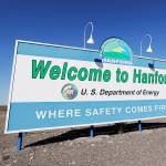 FILE - In this Aug. 13, 2019, file photo, a sign at the Hanford Nuclear Reservation is posted near Richland, Wash. Officials say an underground nuclear waste storage tank that dates to World War II appears to be leaking contaminated liquid into the ground. The U.S. Department of Energy said Thursday, April 29, 2021, that Tank B-109 holds 123,000 gallons of radioactive waste left from the production of plutonium for nuclear weapons on the Hanford Nuclear Reservation. (AP Photo/Elaine Thompson, File)