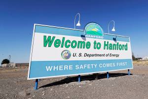 FILE - In this Aug. 13, 2019, file photo, a sign at the Hanford Nuclear Reservation is posted near Richland, Wash. Officials say an underground nuclear waste storage tank that dates to World War II appears to be leaking contaminated liquid into the ground. The U.S. Department of Energy said Thursday, April 29, 2021, that Tank B-109 holds 123,000 gallons of radioactive waste left from the production of plutonium for nuclear weapons on the Hanford Nuclear Reservation. (AP Photo/Elaine Thompson, File)