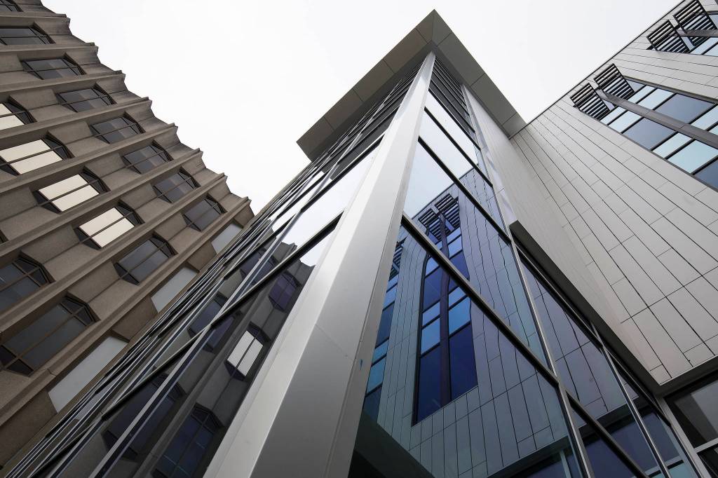 The older building and the new courthouse addition are reflected in windows before a ribbon-cutting ceremony to mark the completion of the courthouse remodel Thursday in Everett. (Andy Bronson / The Herald)