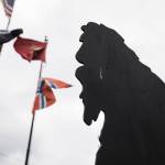 Nathaniel Lindells Bigfoot cutout in Everett stands below the U.S. Marine Corps flag, the flag of Norway, the American flag and the POW/MIA flag. (Olivia Vanni / The Herald)