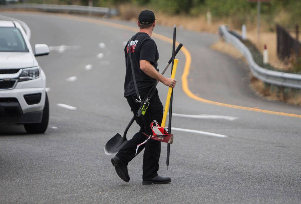 An Everett firefighter at the scene of a possible tunnel collapse along I-5 at Pacific Avenue on Thursday. (Olivia Vanni / The Herald)