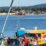 Up Up Up Inc., a traveling circus on a flatbed truck stage with a crane for aerial acts, performs Wednesday in Langley and Friday in Everett on its monthlong Pacific Northwest tour. Its seen here at a show on Guemes Island north of Anacortes. (Submitted photo)