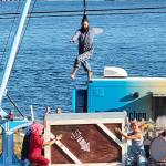 Up Up Up Inc., a traveling circus on a flatbed truck stage with a crane, performs Wednesday in Langley and Friday in Everett on its monthlong Pacific Northwest tour. Seen here at a show on Guemes Island. (Submitted photo)