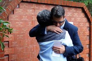 Genna Martin / The Herald
James Snow hugs his mother Ruth Perin after unveiling a tile in honor of his brother Peter John Snow, who was killed by a drunk driver in 1994.  Thirteen new names were added to the DUI victims memorial wall during the ceremony in McCollum Park, Thursday.
Photo taken 090172015
