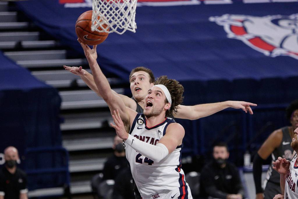 Gonzaga forward Corey Kispert (front) shoots in front of Santa Clara forward Josip Vrankic during the second half of a game on Feb. 25, 2021, in Spokane. (AP Photo/Young Kwak)