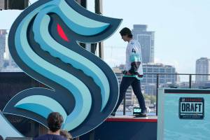 Hadyn Fluery, a defenseman from the Anaheim Ducks, walks off stage after being introduced as a new player with the Seattle Kraken NHL hockey team, Wednesday, July 21, 2021, during the Kraken's expansion draft event in Seattle. (AP Photo/Ted S. Warren)