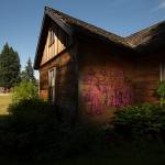 Graffiti can be seen on the back walls of the Pioneer Gehl House in Jennings Memorial Park in Marysville. (Andy Bronson / The Herald)