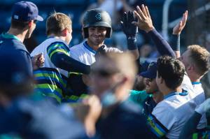 AquaSox's Patrick Frick is congratulated by his teammates after hitting home run during the game against the Dust Devils on Sunday, May 16, 2021 in Everett, Wash.