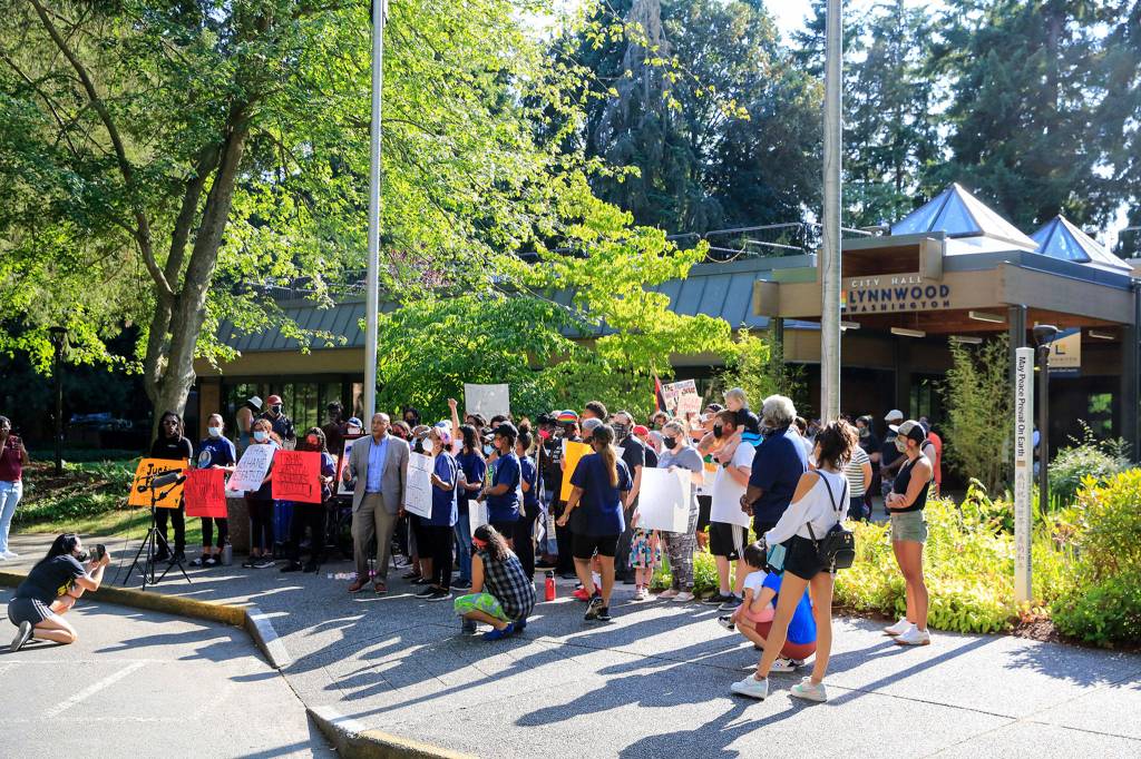 Family and friends of Tirhas Tesfastion and their supporters gather during a rally Monday at Lynnwood City Hall. (Kevin Clark / The Herald)