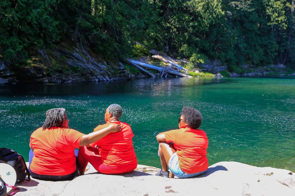 Family and friends gather by the Skykomish River at Eagle Falls in memory of Devin Shelby. (Kevin Clark / The Herald)