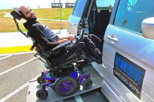 Photo by Heather Mayhugh
Stuart Peeples demonstrates how to enter Heather Mayhugh's wheelchair van. In recent months, while navigating the new Mukilteo ferry terminal, Mayhugh has struggled to unload her clients who need access to the restroom.
