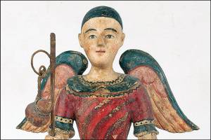 The 13-inch-high antique wooden San Rafael figure with wings and holding a staff and a fish sold at a Cottone auction for $9,600. (Cowles Syndicate Inc.)