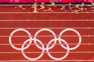 Runners pass the Olympic rings as they compete during the first round of the womens 5,000-meter at the 2020 Summer Olympics on Friday in Tokyo. (AP Photo/Morry Gash)