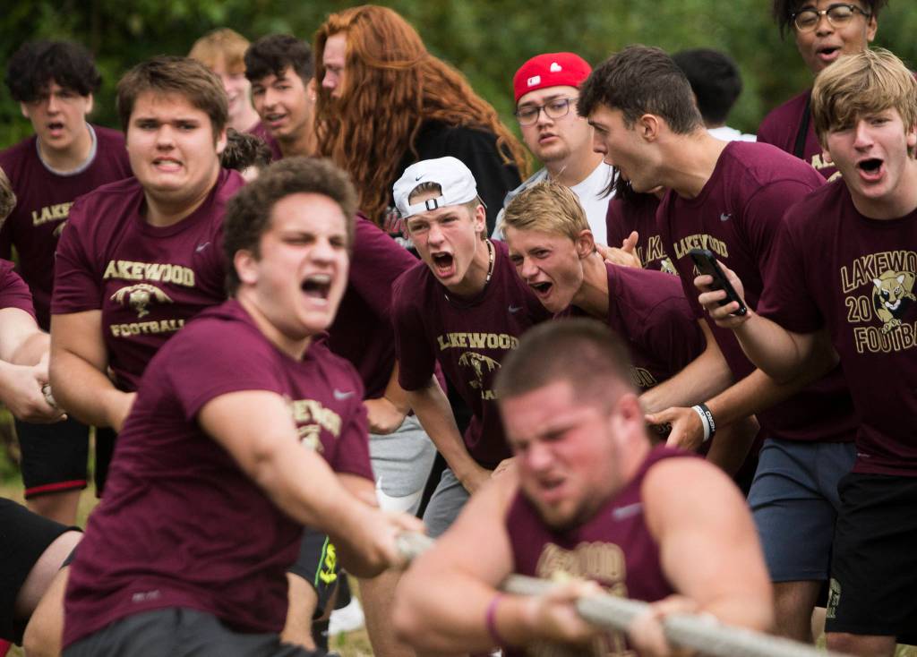 Lakewood High School football players cheer on their lineman during the Cougars Championship Lineman Challenge at Lakewood High School on July 31 in Arlington. (Olivia Vanni / The Herald)