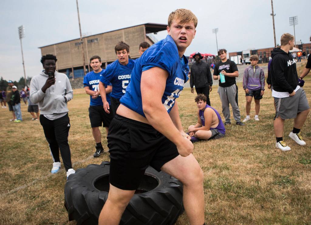 Bothells Luka Vincic reacts after his team wins the Tire Flip Relay during the Cougars Championship Lineman Challenge at Lakewood High School on July 31 in Arlington. (Olivia Vanni / The Herald)