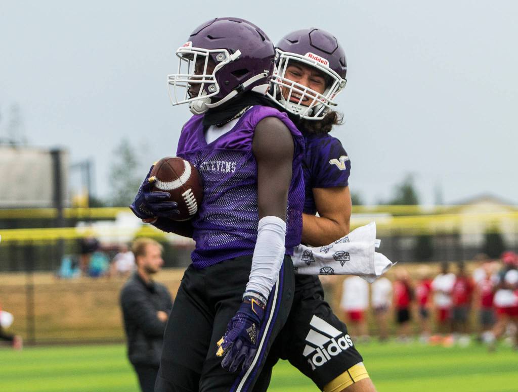 Lake Stevens Isaac Redford (left) and Drew Carter (right) celebrate a touchdown during the Cougars Championship Passing Tournament at Lakewood High School on July 31 in Arlington. (Olivia Vanni / The Herald)