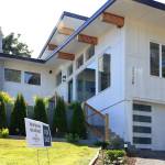 Real estate agent Randi Szakaly of Windermere Real Estate in Everett stands outside a listing in Mukilteo. (Kevin Clark / The Herald)