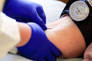 JaNeen Aagaard donates blood at Bloodworks NW Friday afternoon in Everett at July 30, 2021.  (Kevin Clark / The Herald)