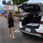 Before every delivery, Danielle Lam with the Prize Patrol from Publishers Clearing House fills balloons and gets flowers for the winner. (Andy Bronson / The Herald)