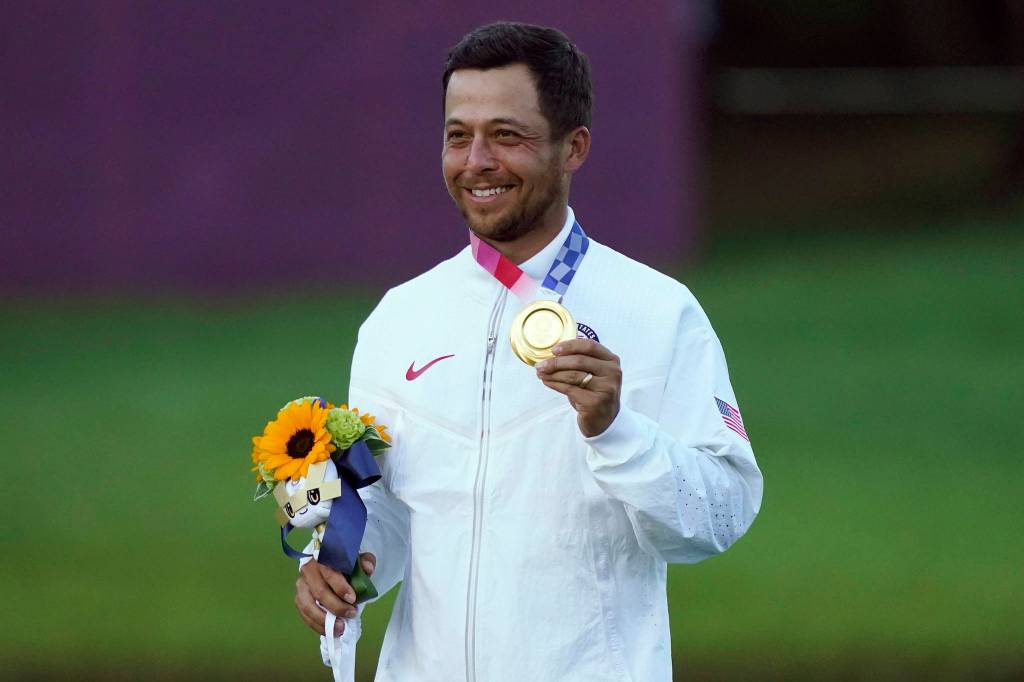 Xander Schauffele, of the United States, holds his gold medal after winning the men's golf event at the 2020 Summer Olympics, Sunday, Aug. 1, 2021, at the Kasumigaseki Country Club in Kawagoe, Japan, (AP Photo/Matt York)
