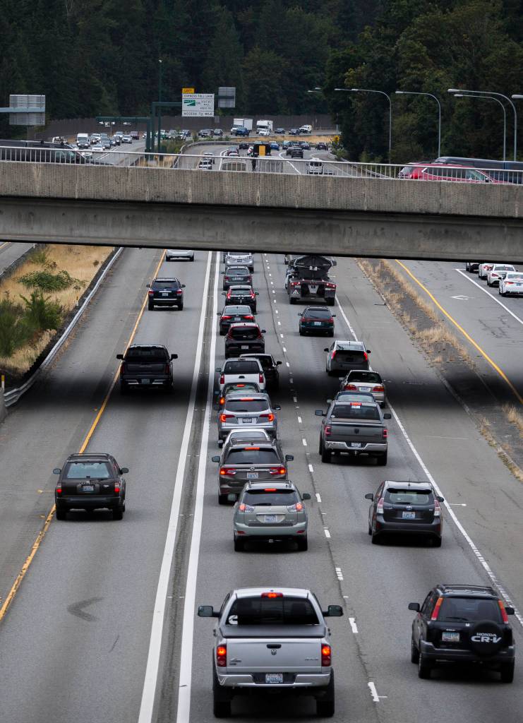 General purpose lane traffic on I-405 north stops underneath the overpass of Highway 527 while express toll lane traffic on the left moves Friday in Bothell. The state plans to build a second toll lane between Highways 522 and 527. (Olivia Vanni / The Herald)