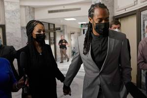 Richard Sherman, right, holds hands with his wife Ashley, Friday, July 16, 2021, as they walk following a King County District Court hearing in Seattle. The NFL football cornerback, who has played with the Seattle Seahawks and the San Francisco 49ers, was arraigned on five criminal charges Friday after he was arrested Wednesday after police said he crashed his car in a construction zone along a busy highway east of Seattle and then tried to break into his in-laws' home in the suburb of Redmond, Wash. (AP Photo/Ted S. Warren)