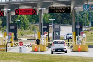 FILE - In this June 8, 2021, file photo, a car approaches one of the few lanes open at the Peace Arch border crossing into the U.S. in Blaine, Wash. Canada is lifting its prohibition Monday, Aug. 9 on Americans crossing the border to shop, vacation or visit, but the United States is keeping similar restrictions in place for Canadians. The reopening is part of a bumpy return to normalcy from COVID-19 travel bans.  (AP Photo/Elaine Thompson, File)