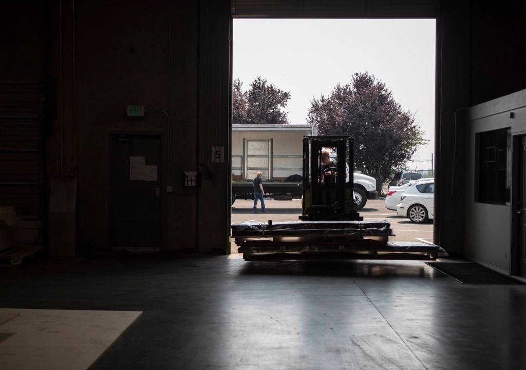 Products are hauled into the Ironwood Manufacturing building in Arlington. (Olivia Vanni / The Herald)