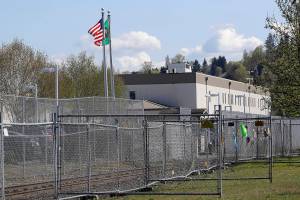 The Northwest Detention Center is shown, Wednesday, April 15, 2020, in Tacoma, Wash. on the day of a during a car-based protest showing support for detainees inside who were taking part in a hunger strike to protest conditions they say are inadequate to protect detainees from the spread of the coronavirus. (AP Photo/Ted S. Warren)