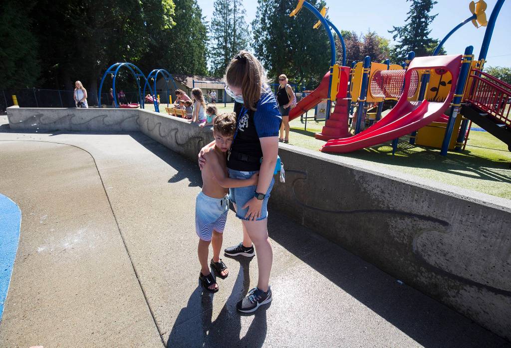 A moment of frustration finds Haaken Williams holding onto Camp Prov unit leader Sarah Walters at Forest Park in Everett on Wednesday. (Andy Bronson / The Herald)