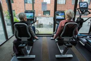Jean Kinity, left, and Sandra Barton chats as they try out the new recumbent bikes at the Carl Gipson Senior Center's new fitness room on Tuesday, Oct. 15, 2019 in Everett, Wash. (Olivia Vanni / The Herald)