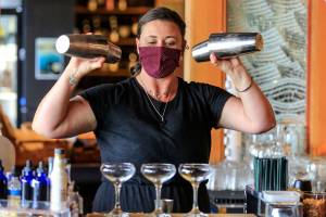 Madison Bauer mixes drinks Wednesday afternoon at Bluewater Organic Distilling in Everett on August 25, 2021. (Kevin Clark / The Herald)