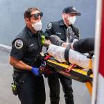 Paramedics Cody Miller (left) and Justin Jones respond to a heat exposure call during the late-June heat wave in Salem, Ore. (Nathan Howard / Associated Press file photo)
