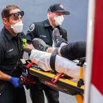 Paramedics Cody Miller, left, and Justin Jones respond to a heat exposure call during a heat wave, Saturday, June 26, 2021, in Salem, Ore. (AP Photo/Nathan Howard)