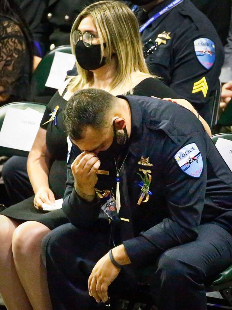 Tulalip Fish & Wildlife Officer Beau Jess mourns his lifelong friend and fellow officer, Charlie Joe Cortez, on Tuesday at Angel of the Winds Arena in Everett. (Kevin Clark / The Herald)