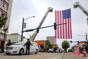 Officers escort symbolic remains of Officer Charlie Joe Cortez Tuesday afternoon at the Angel of the Winds Arena in Everett on August 17, 2021.  (Kevin Clark / The Herald)
